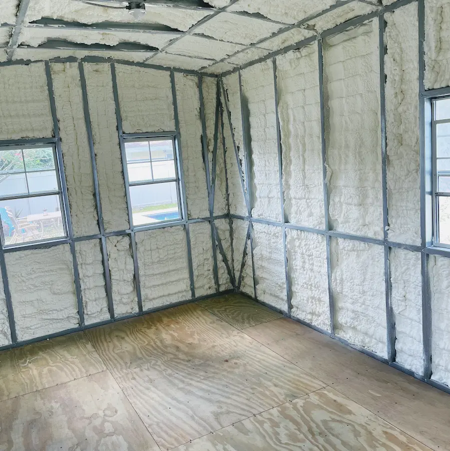 Closed-cell spray foam insulation applied to wall cavities in a residential project in Olean